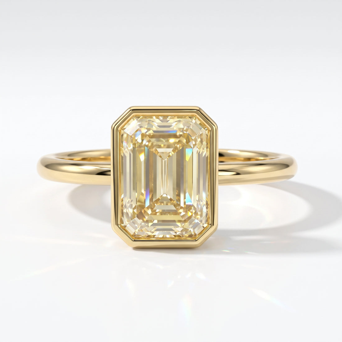 Fancy Intense Yellow emerald cut lab-grown diamond bezel ring in 14K (585) yellow gold, top view 