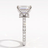 Emerald cut lab-grown diamond hidden halo collar engagement ring with pavé band in 18K (750) white gold, side view 