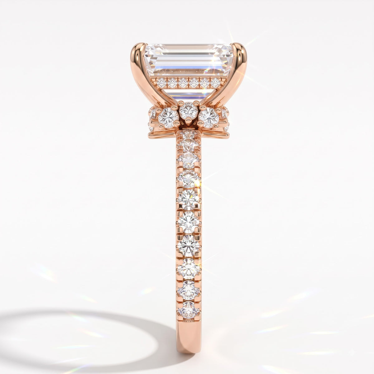 Emerald cut lab-grown diamond hidden halo collar engagement ring with pavé band in 18K (750) rose gold, side view 