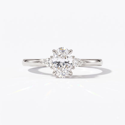 Oval cut lab-grown diamond three-stone engagement ring with pear side stones in 14K (585) white gold, front view 