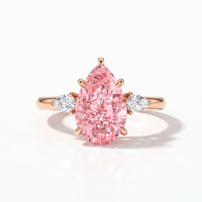 Fancy Vivid Pink pear cut lab-grown diamond three-stone ring with pear side diamonds in 14K (585) rose gold, front view 