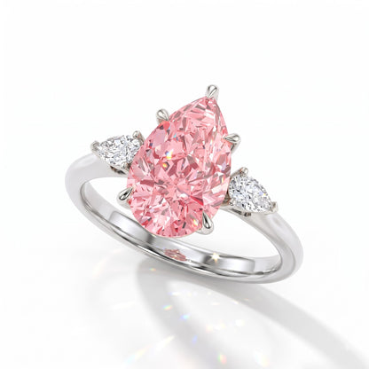 Fancy Vivid Pink pear cut lab-grown diamond three-stone ring with pear side diamonds in 14K (585) white gold, angled view 