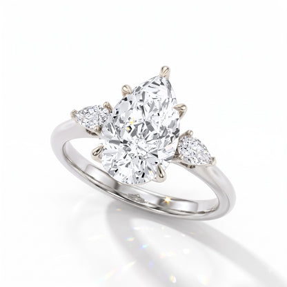 Pear cut lab-grown diamond three-stone engagement ring with pear side stones in 14K (585) white gold, angled view 