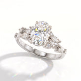 Oval lab-grown diamond cluster engagement ring with marquise and round leaf accents in 14K (585) white gold, angled view 