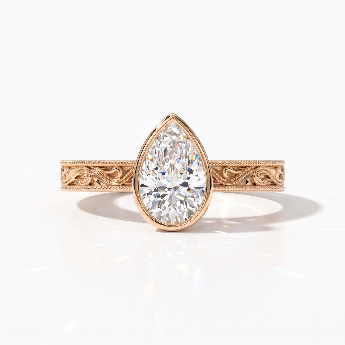 Pear cut lab-grown diamond vintage bezel engagement ring with hand-engraved milgrain band in 14K (585) rose gold, front view 