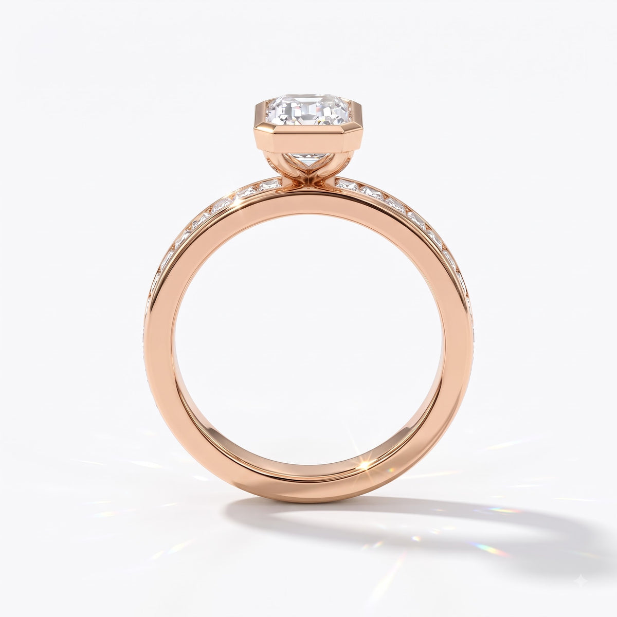 Emerald cut lab-grown diamond bezel engagement ring with channel-set baguette diamonds in 14K (585) rose gold, upright profile view 