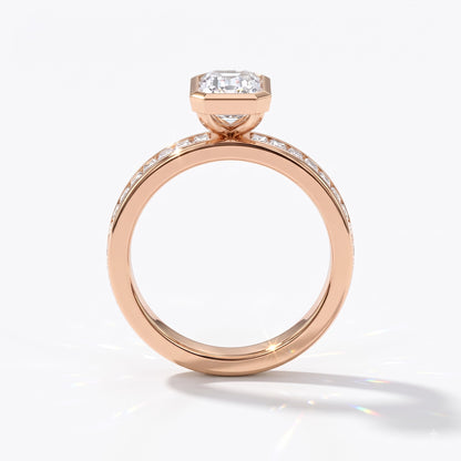 Emerald cut lab-grown diamond bezel engagement ring with channel-set baguette diamonds in 14K (585) rose gold, upright profile view 