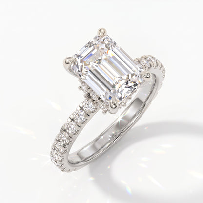 Emerald cut lab-grown diamond hidden halo collar engagement ring with pavé band in 950 platinum, angled view 