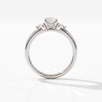 Oval cut lab-grown diamond three-stone engagement ring with pear side stones in 18K (750) white gold, upright profile view 