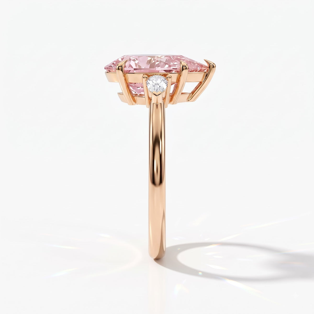 Fancy Vivid Pink pear cut lab-grown diamond three-stone ring with pear side diamonds in 18K (750) rose gold, side view 