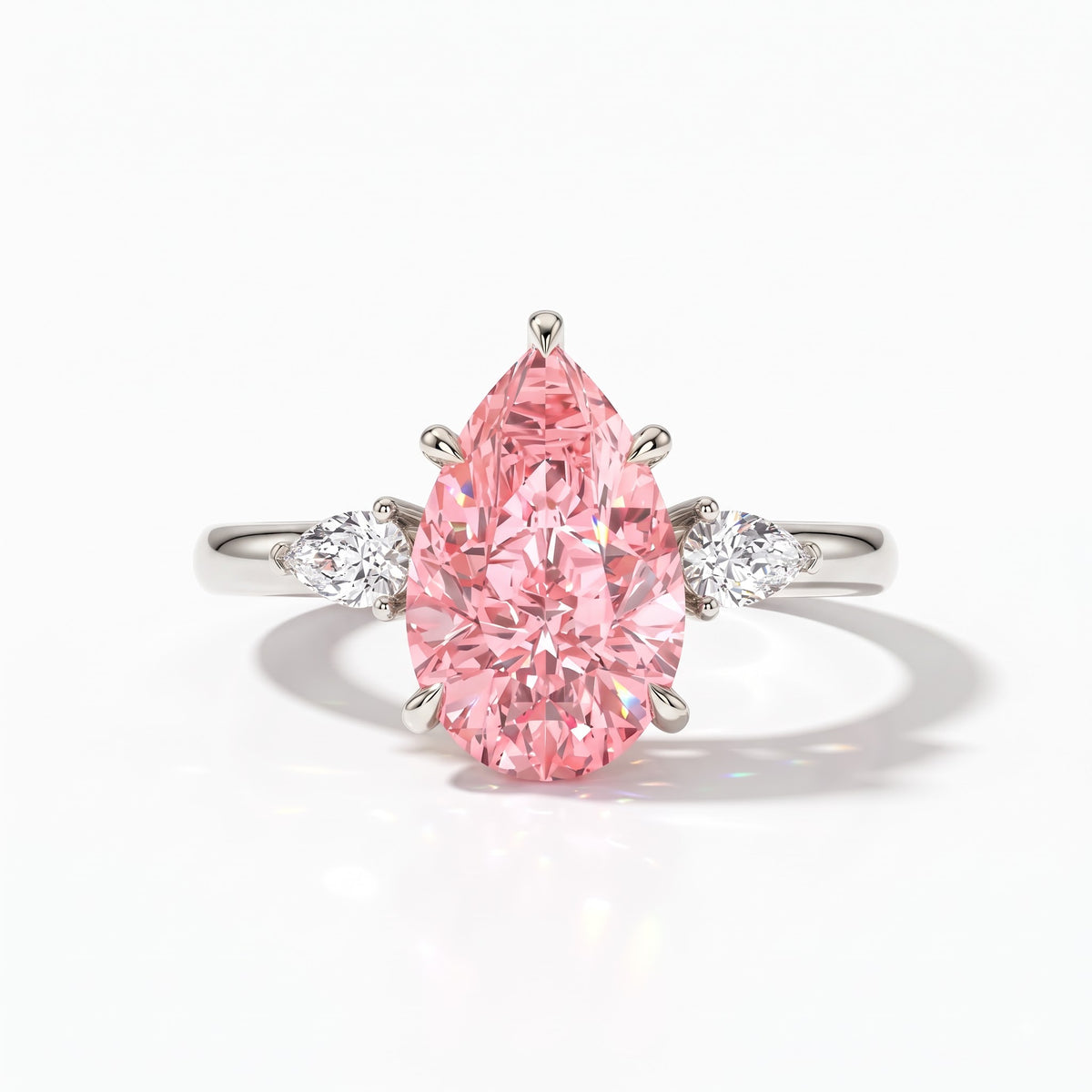 Fancy Vivid Pink pear cut lab-grown diamond three-stone ring with pear side diamonds in 18K (750) white gold, front view 