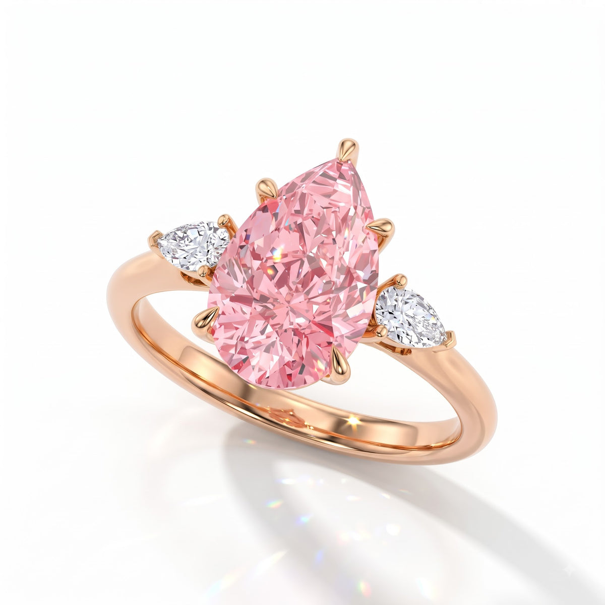 Fancy Vivid Pink pear cut lab-grown diamond three-stone ring with pear side diamonds in 18K (750) rose gold, angled view 