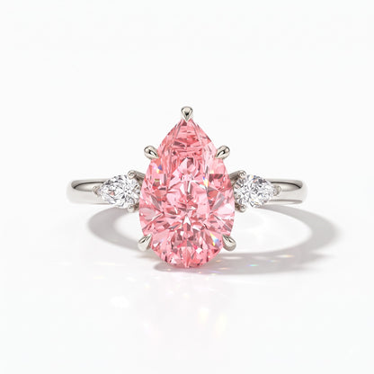Fancy Vivid Pink pear cut lab-grown diamond three-stone ring with pear side diamonds in 950 platinum, front view 
