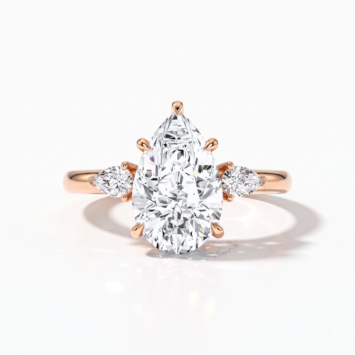 Pear cut lab-grown diamond three-stone engagement ring with pear side stones in 18K (750) rose gold, front view 