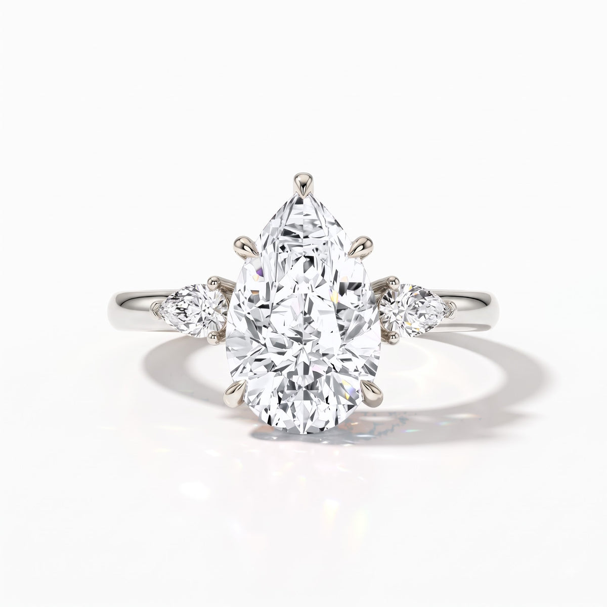 Pear cut lab-grown diamond three-stone engagement ring with pear side stones in 18K (750) white gold, front view 