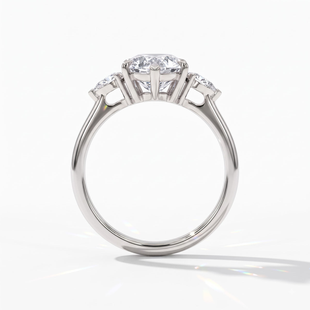Pear cut lab-grown diamond three-stone engagement ring with pear side stones in 18K (750) white gold, upright profile view 