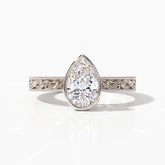 Pear cut lab-grown diamond vintage bezel engagement ring with hand-engraved milgrain band in 18K (750) white gold, front view 