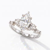 Marquise cut lab-grown diamond cluster engagement ring with marquise and round leaf accents in 18K (750) white gold, angled view 