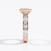 Emerald cut lab-grown diamond bezel engagement ring with channel-set baguette diamonds in 18K (750) rose gold, side view 