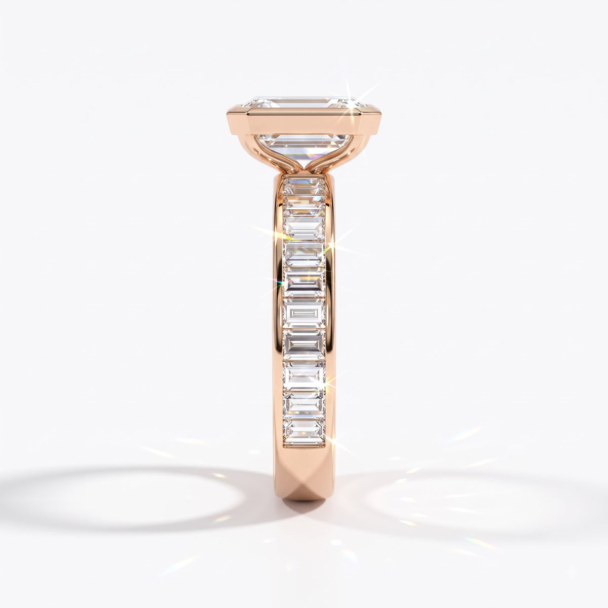Emerald cut lab-grown diamond bezel engagement ring with channel-set baguette diamonds in 18K (750) rose gold, side view 