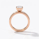Emerald cut lab-grown diamond bezel engagement ring with channel-set baguette diamonds in 18K (750) rose gold, upright profile view 