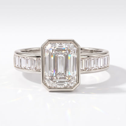 Emerald cut lab-grown diamond bezel engagement ring with channel-set baguette diamonds in 18K (750) white gold, front view 