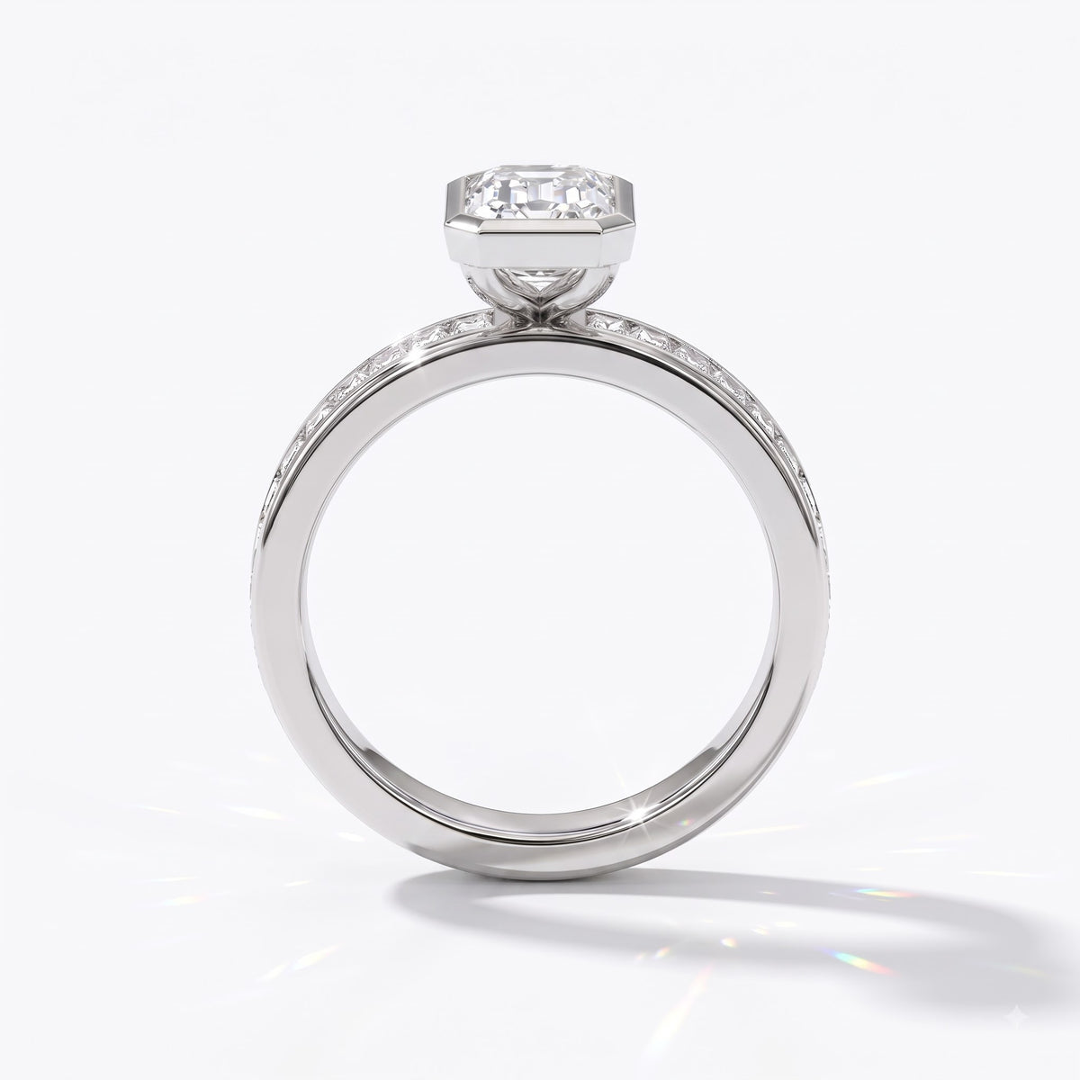 Emerald cut lab-grown diamond bezel engagement ring with channel-set baguette diamonds in 950 platinum, upright profile view 