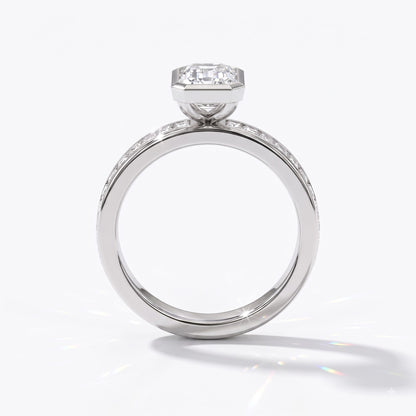 Emerald cut lab-grown diamond bezel engagement ring with channel-set baguette diamonds in 950 platinum, upright profile view 