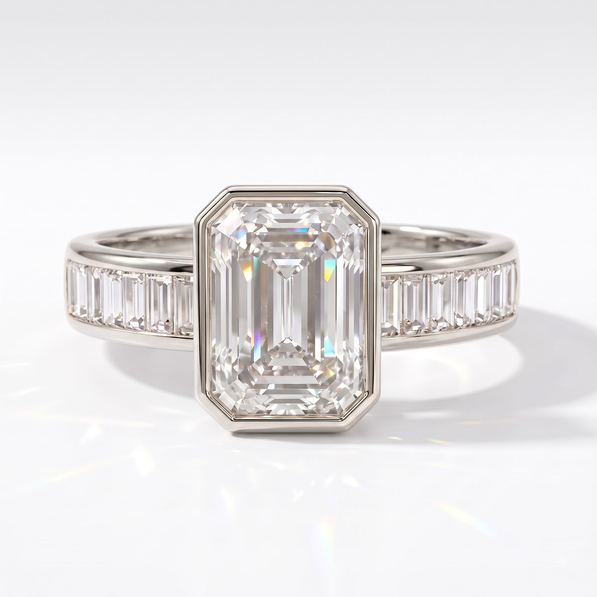 Emerald cut lab-grown diamond bezel engagement ring with channel-set baguette diamonds in 950 platinum, front view 
