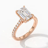 Emerald cut lab-grown diamond hidden halo engagement ring with pavé band in 14K (585) rose gold, angled view 