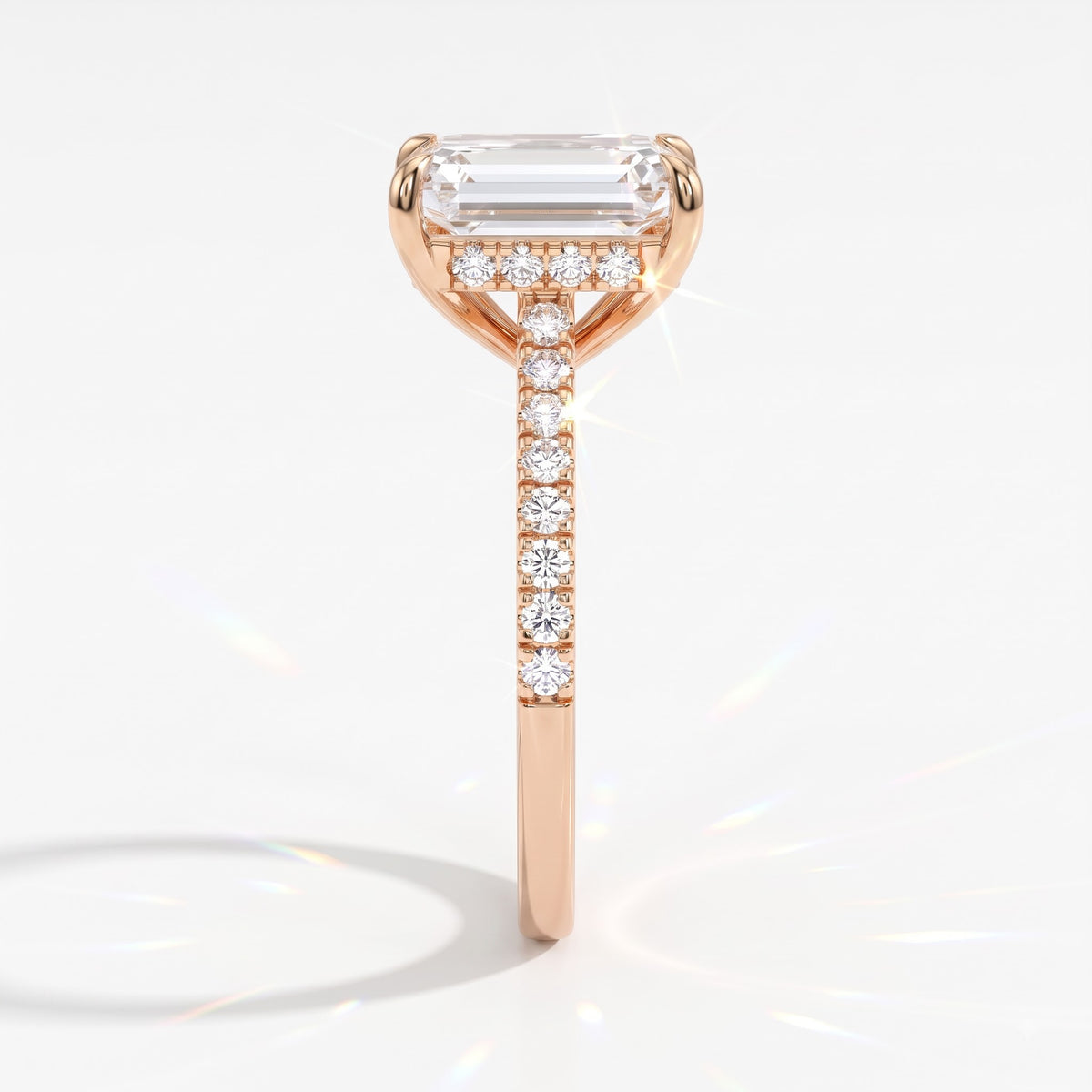 Emerald cut lab-grown diamond hidden halo engagement ring with pavé band in 18K (750) rose gold, side view 