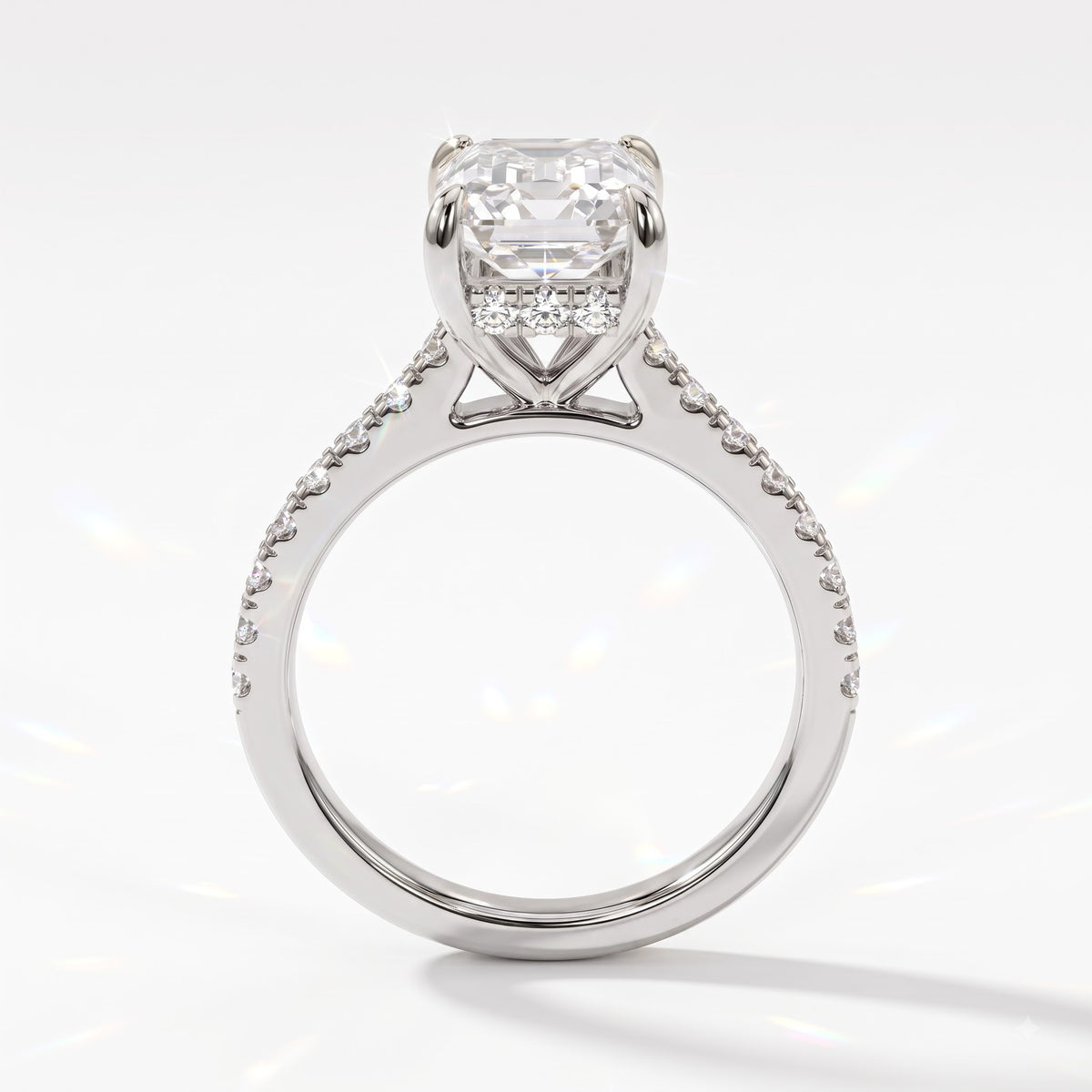 Emerald cut lab-grown diamond hidden halo engagement ring with pavé band in 18K (750) white gold, upright profile view 