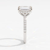 Emerald cut lab-grown diamond hidden halo engagement ring with pavé band in 950 platinum, side view 