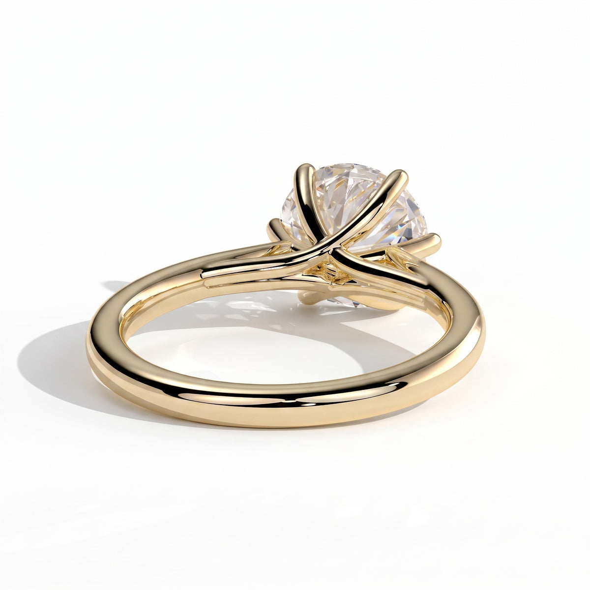 Round lab-grown diamond solitaire engagement ring in 18K (750) yellow gold, on white background 