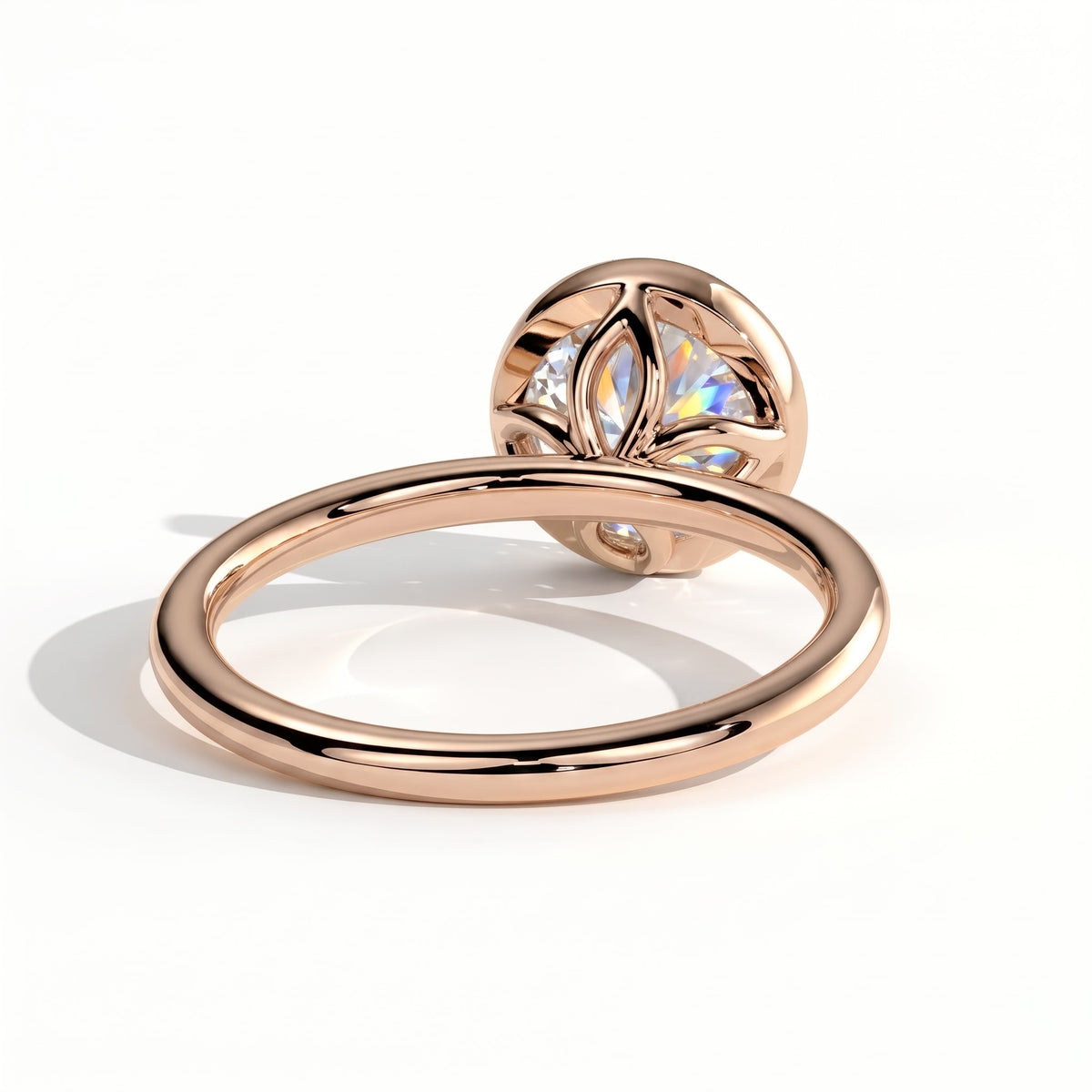 Round lab-grown diamond bezel-set solitaire engagement ring in 14K (585) rose gold, on white background 