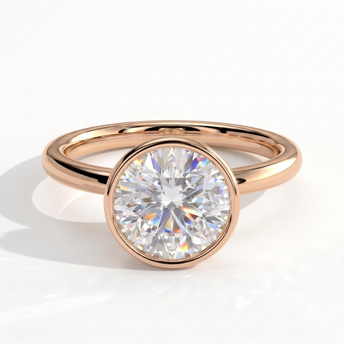 Round lab-grown diamond bezel-set solitaire engagement ring in 14K (585) rose gold, front view 