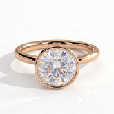 Round lab-grown diamond bezel-set solitaire engagement ring in 14K (585) rose gold, front view 