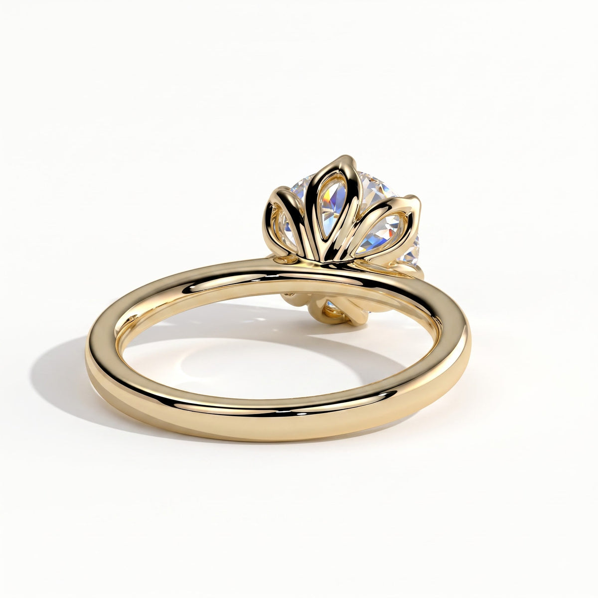 Round lab-grown diamond solitaire engagement ring in 18K (750) yellow gold, on white background 
