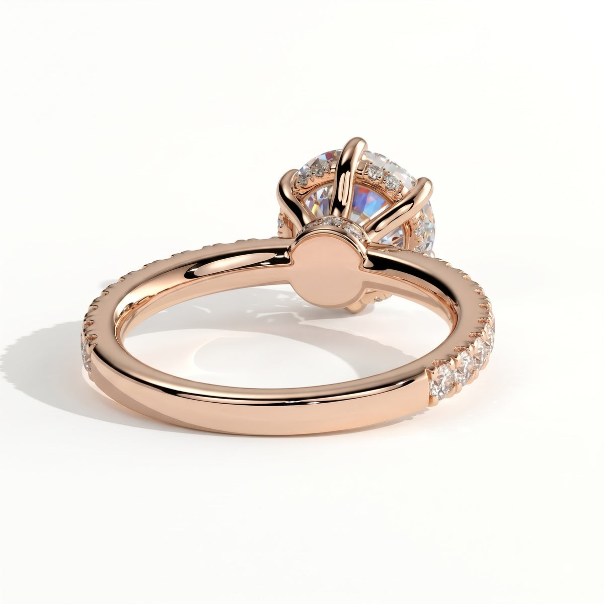 Round lab-grown diamond halo engagement ring in 18K (750) rose gold, on white background 