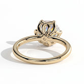 Round lab-grown diamond halo engagement ring in 14K (585) yellow gold, on white background 