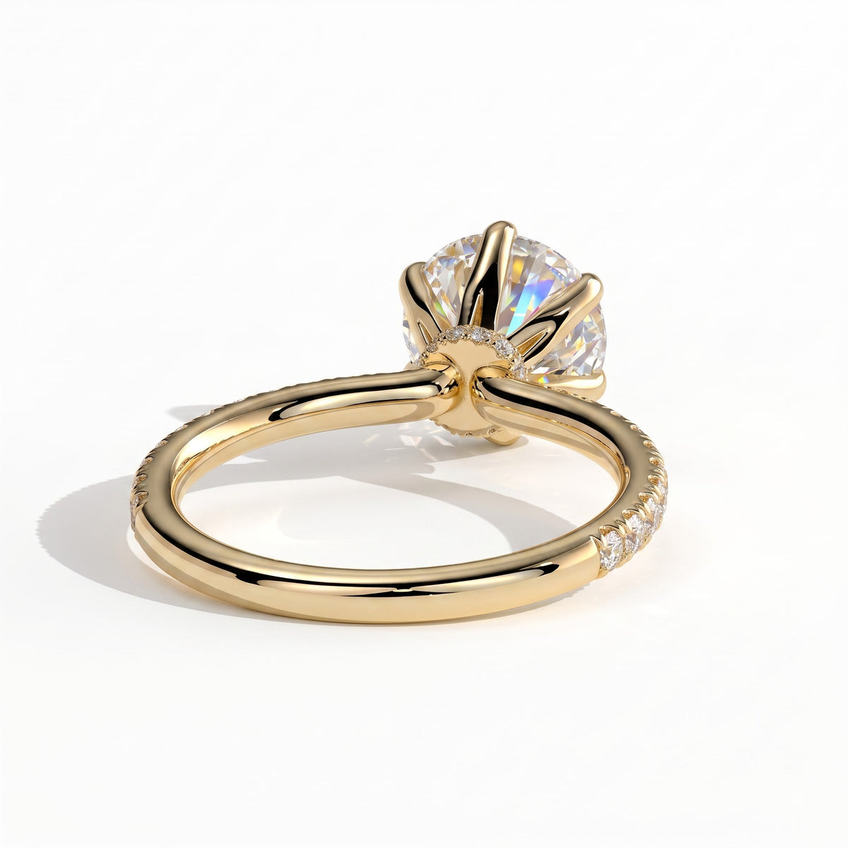 Round lab-grown diamond halo engagement ring in 14K (585) yellow gold, on white background 