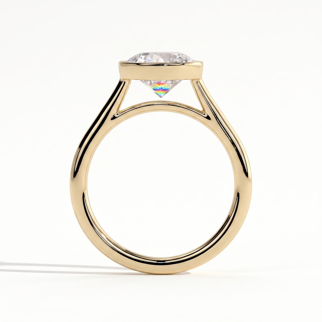 Round lab-grown diamond bezel-set solitaire engagement ring in 14K (585) yellow gold, side profile 