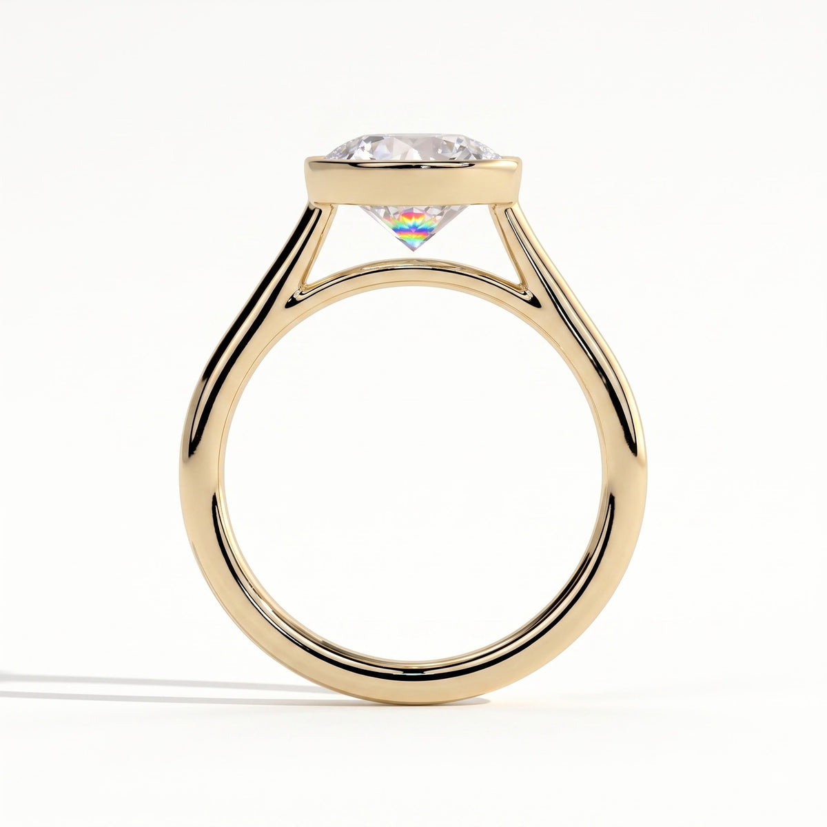 Round lab-grown diamond bezel-set solitaire engagement ring in 14K (585) yellow gold, side profile 