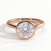 Round lab-grown diamond bezel-set solitaire engagement ring in 14K (585) rose gold, front view 