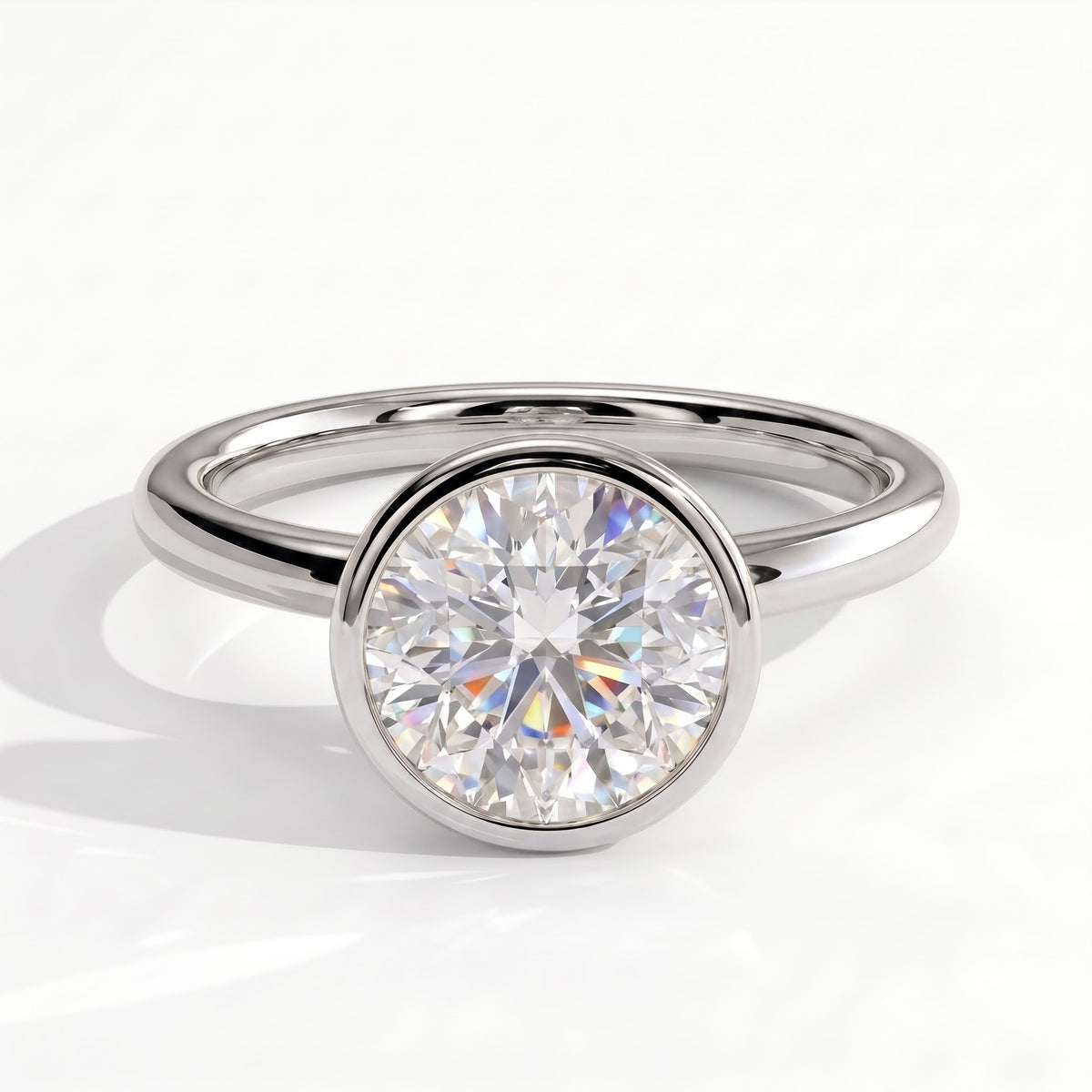 Round lab-grown diamond bezel-set solitaire engagement ring in 14K (585) white gold, front view 