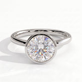 Round lab-grown diamond bezel-set solitaire engagement ring in 18K (750) white gold, front view 