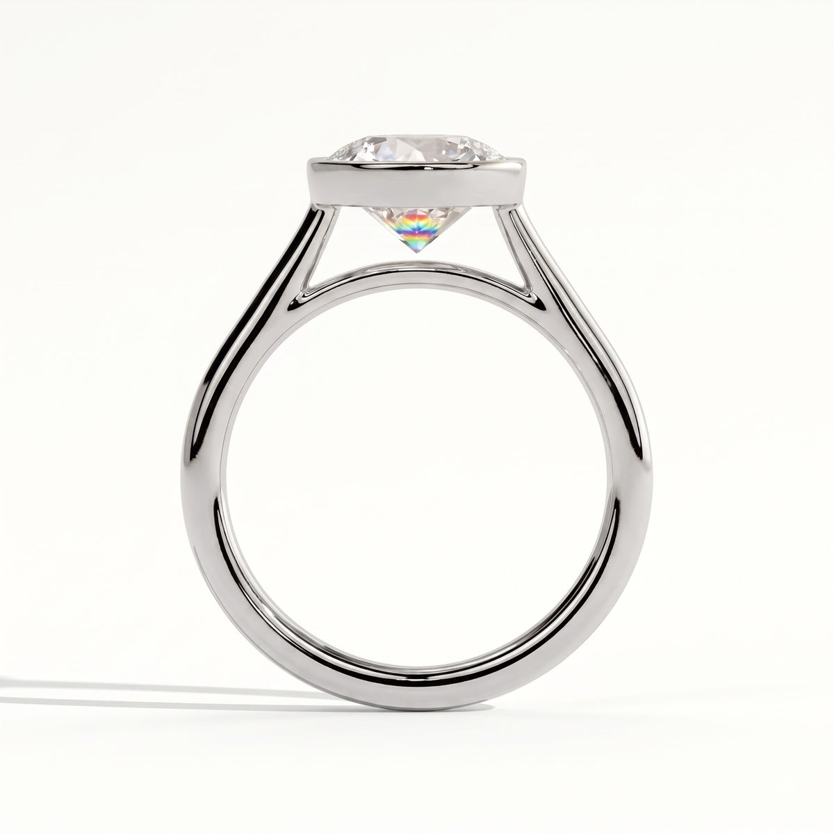 Round lab-grown diamond bezel-set solitaire engagement ring in 950 platinum, side profile 