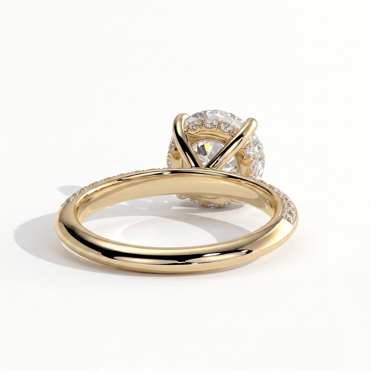 Round lab-grown diamond halo engagement ring in 14K (585) yellow gold, on white background 