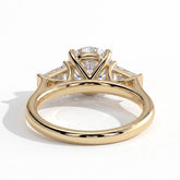 Round lab-grown diamond three-stone engagement ring in 18K (750) yellow gold, on white background 