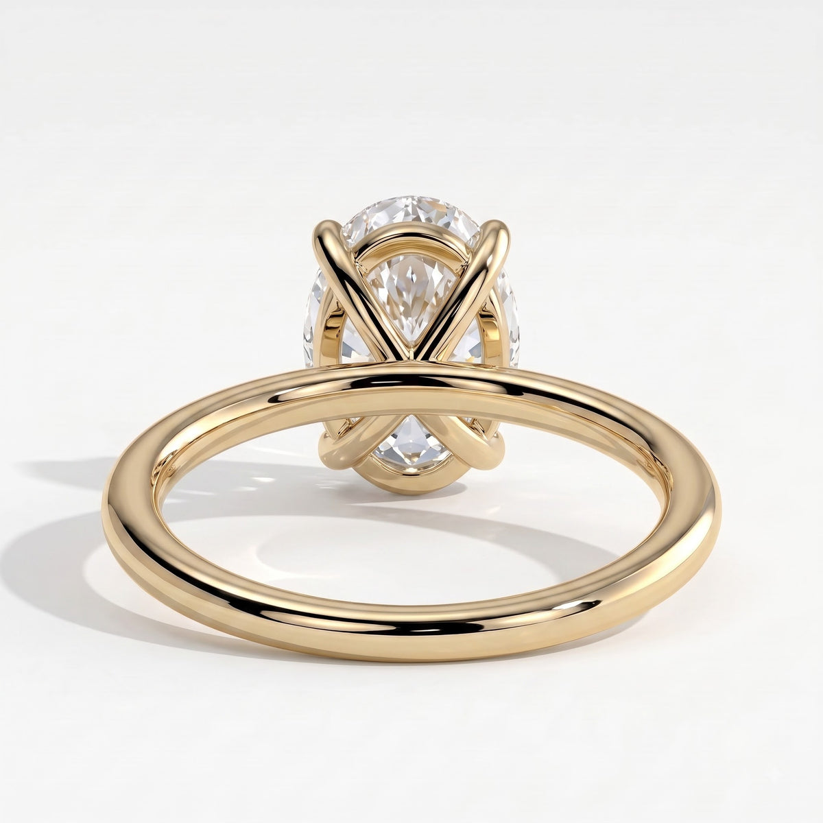 Oval lab-grown diamond solitaire engagement ring in 14K (585) yellow gold, on white background 